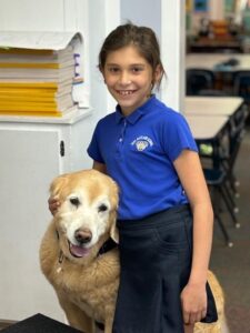 Senior golden posing with child.