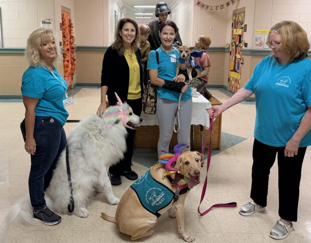 Hearts of Gold dogs visiting, a school.