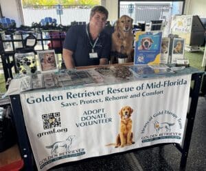 Photo of Charlie and Lala behind the GRRMF information table.