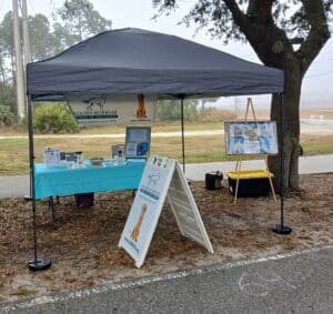 A GRRMF information booth set up at an event, with table and tent.