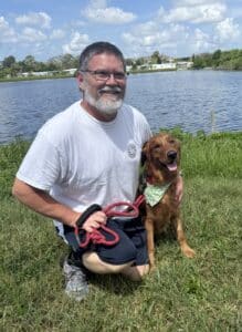 A photo of Marley, a red golden, with adopted dad.