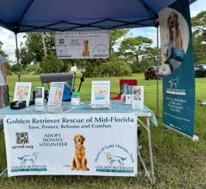 GRRMF information booth set up outdoors under a blue canopy tent.